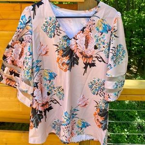 A pink floral pull over top